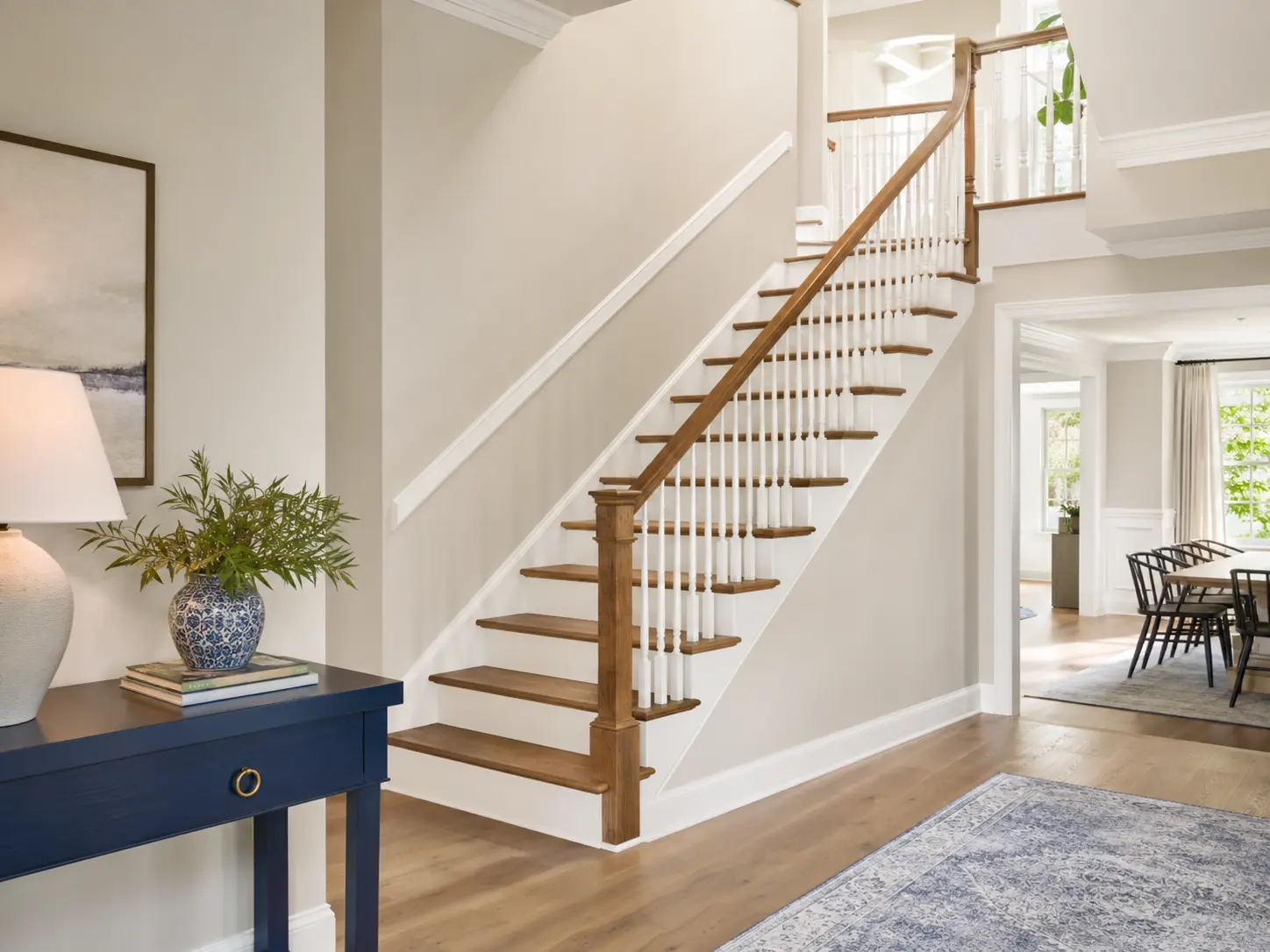 Elegant interior staircase with white wainscoting and a professional paint finish